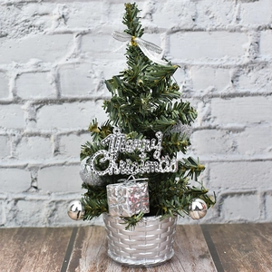 Mini silver decorated Christmas tree in basket for holiday tabletop display