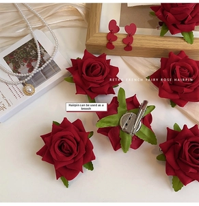 Close-up of retro velvet rose hair clip with dual brooch pin and metal duckbill clip