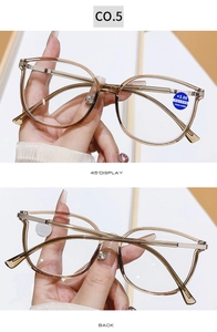 Detail of +3.00 reading glasses showing silver hinge and transparent brown frame