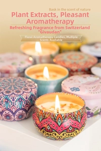 Detail of soy wax candles with dried flowers in tin cans with bohemian patterns