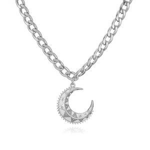 Detail of silver link chain necklace with crescent moon pendant featuring clear crystals