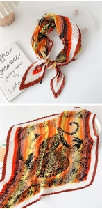 Close-up of pleated silk scarf featuring jungle leopard print and scalloped wavy edges