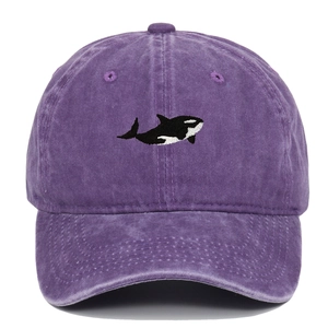 Close-up of black and white orca embroidery on purple washed cotton baseball cap texture