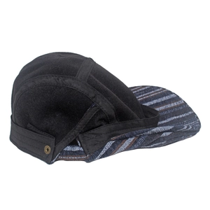Detail view of cotton striped beret featuring adjustable metal eyelets and warm tweed fabric