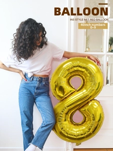 Detailed view of a large 40-inch gold foil number 8 balloon for birthday party decoration