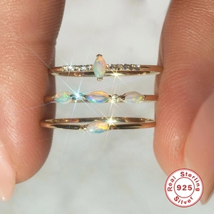 Close-up of S925 sterling silver opal stacking rings set with marquise cut gems