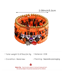 Detail view of Halloween layered bracelet set with pumpkin, ghost charms and BOO beads