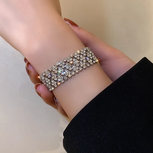 Detailed view of wide silver-tone bracelet with five rows of pavé-set sparkling crystals