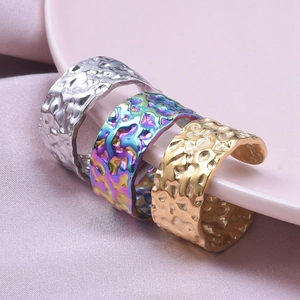 Close-up of hammered 304 stainless steel rings in gold, silver, and rainbow colors