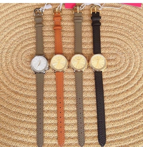Detailed group shot of leather strap quartz watches with diamond bezels and mother of pearl dials