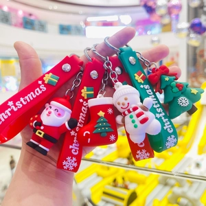 Detail showing silicone Christmas keychains with Santa, snowman and tree on red straps