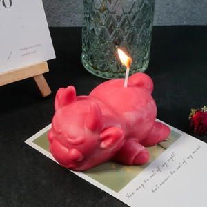 Realistic matte red bulldog-shaped candle in a cozy setting with a burning wick
