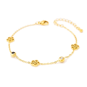 Golden titanium steel bracelet with hollow camellia charms and black and white crystals