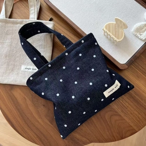 Polka dot denim and linen tote bags set on a rustic wooden table in a lifestyle setting