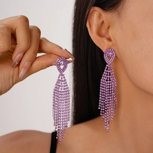 Luxurious purple rhinestone long tassel drop earrings worn by a model in soft lighting