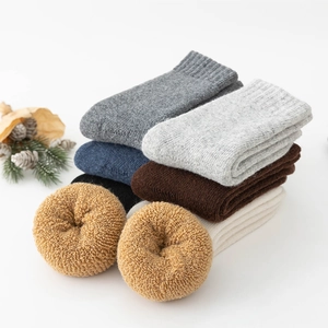 Detail view of thick wool socks in multiple colors with natural texture and soft feel