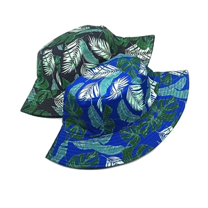 Tropical leaf print bucket hats for men and women in black and blue floral patterns