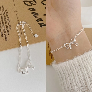 Detailed view of S925 silver bow bracelet with adjustable chain and heart pendant