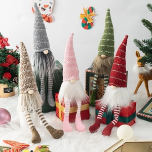 Set of five Christmas gnomes with striped legs and knit hats on festive holiday decor