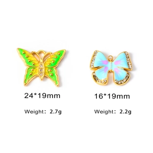Detail of colorful butterfly pendants with enamel finish and sizes 24x19mm and 16x19mm