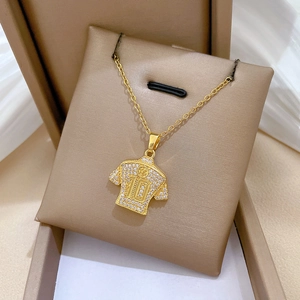 Close-up of gold jersey number 10 pendant with shimmering rhinestones in a gift box