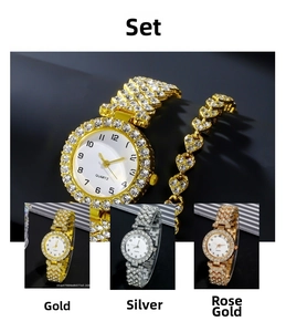 Close-up of luxury rhinestone quartz watch and heart-shaped bracelet set in gold and silver