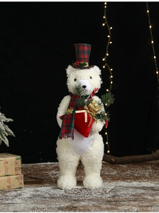 Detail of a white curly plush Christmas polar bear with red plaid hat and gift box