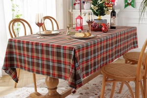 Detailed view of red and green plaid festive tablecloth with elegant fabric drape texture