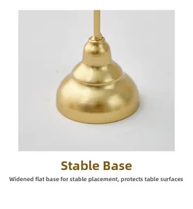 Detail of a matte brushed gold metal candle holder base with a wide stable design