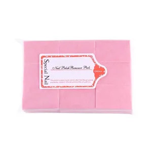 Pink lint-free nail polish remover pads in transparent packaging made of natural cotton fiber