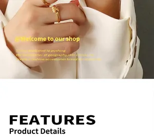 Close-up of golden knot ring on model's hand styled with a chic white blazer