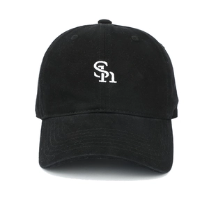 Detail of high-quality white SH letter embroidery on a black cotton baseball cap