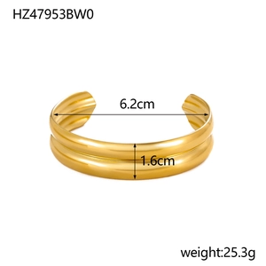 Detail view of gold wide C-shape bangle with 1.6cm width and 6.2cm inner diameter