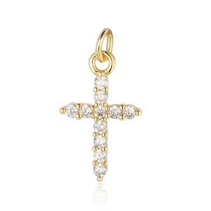 Macro shot of gold-plated cross pendant with clear cubic zirconia stones on white background