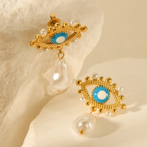 18k gold plated evil eye earrings with baroque pearls on a natural stone background