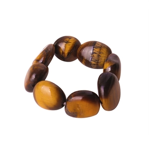 Elastic tiger eye stone ring featuring natural brown striped gemstones on a white background