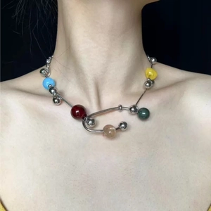Colorful mixed bead necklace with silver chain and metal spheres worn by a model