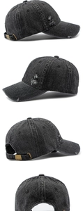 Detail view of washed denim baseball cap with distressed holes and metal buckle