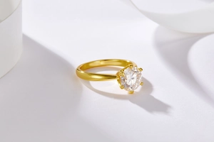 Macro shot of 18K gold-plated six-prong setting with a brilliant round moissanite stone