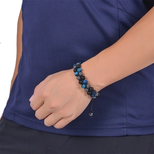 Detail of double-layer men's beaded bracelet featuring tiger eye stones and adjustable cord