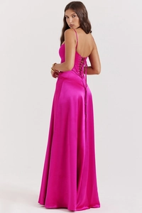 Detail of hot pink satin dress featuring cross-back corset ties and silky flowing fabric