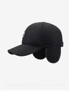 Detail of winter wool baseball cap with ear flaps and fabric label in black