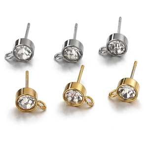 Detailed view of gold and silver cubic zirconia earring posts with hanging loop connectors