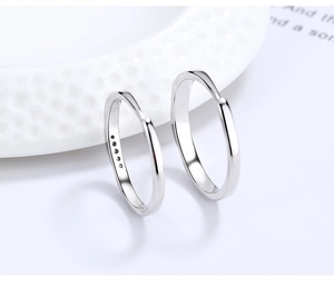 Close-up of 925 sterling silver couple rings with S925 hallmark and cubic zirconia stones