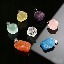 Detailed view of colorful mushroom-shaped natural stone pendants on a dark surface