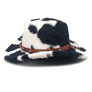 Close-up of cow print cowboy hat with brown faux leather band and turquoise studs