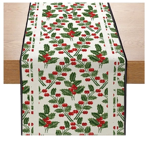 Detailed close-up of Christmas table runner with red berries and holly leaf pattern