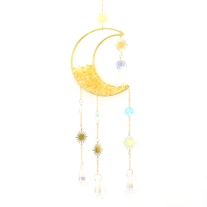 Detail of moon sun catcher with yellow crystal chips and golden celestial pendants