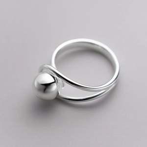 Minimalist silver dual-band ring with sphere detail on a clean grey background