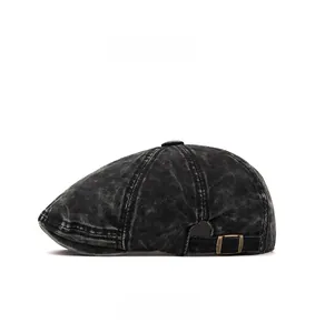 Detailed side view of washed denim beret with vintage brass adjustable buckle closure